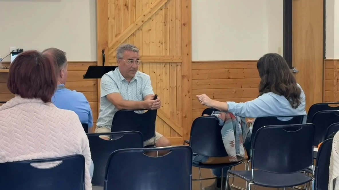 Mark P. Fisher seated in a circle, facilitating a candid conversation